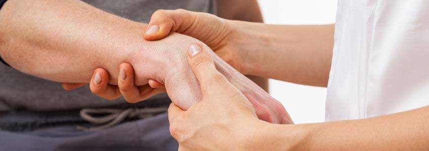A health specialist holding the wrist of a patient