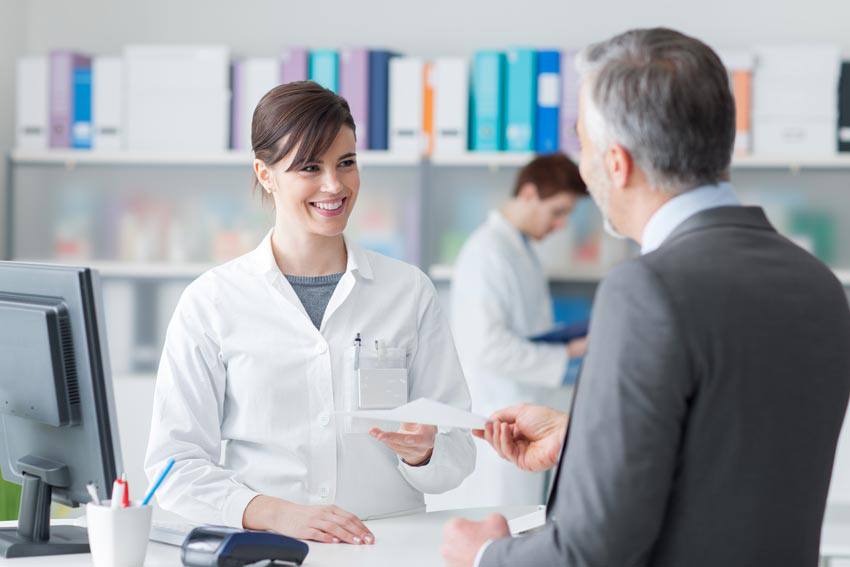 A pharmacist helping a customer at the counter