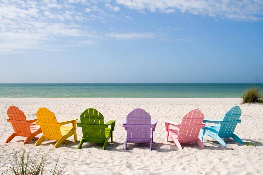 Six beach chairs with different colors on the beach