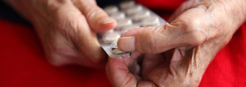 An old person taking pills