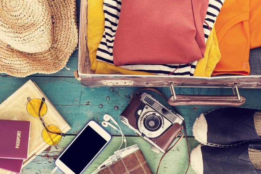 A collection of apparel, electronics and books on the floor