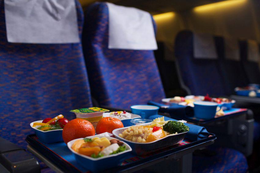 Airplane seats with full meals on the seat trays