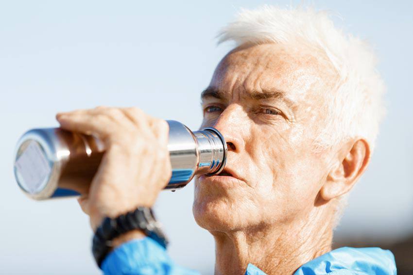 A man drinking water from a bottle