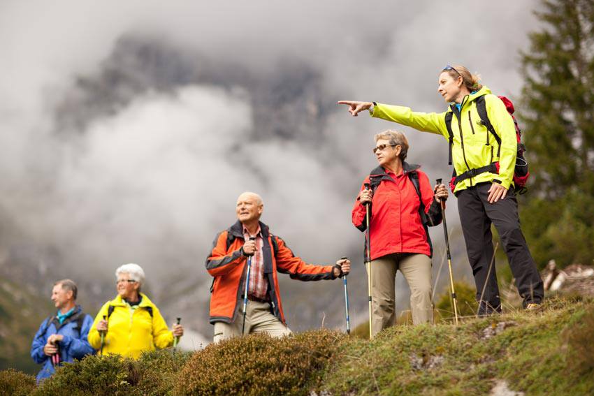 Group of elderly people hiking in the mountain