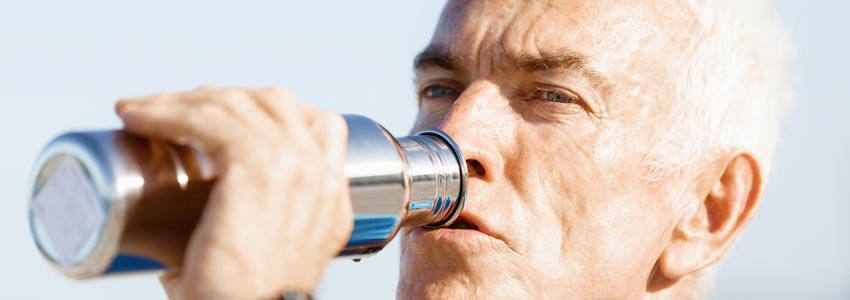 A man drinking water from a bottle