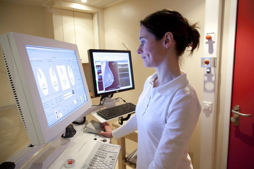 A woman analyzing the pictures of a mammogram
