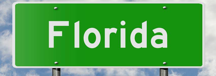 A green street sign written 