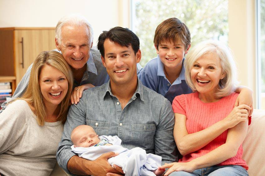 Happy family holding a new born baby