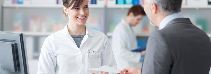 A pharmacist helping a customer at the counter