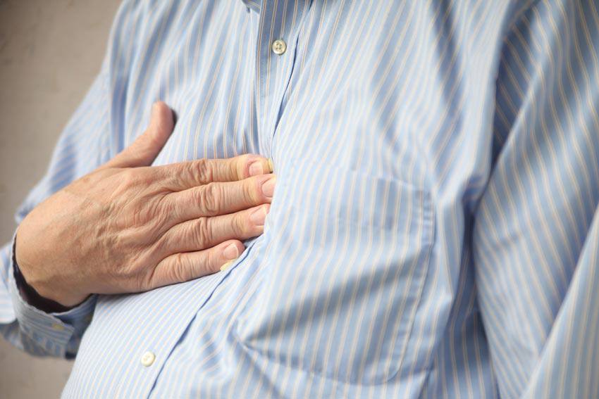 A person pressing on their chest with their hand