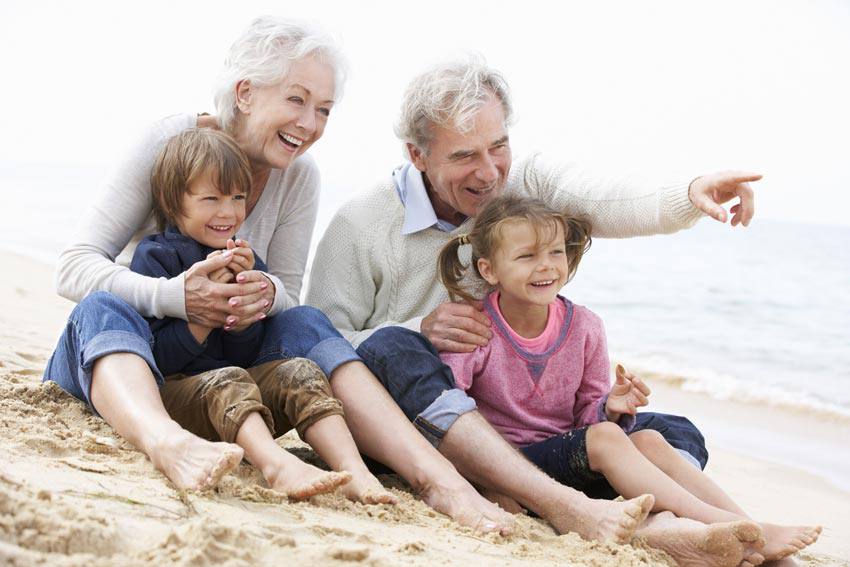 Grandparents at the beach with their grandchildren