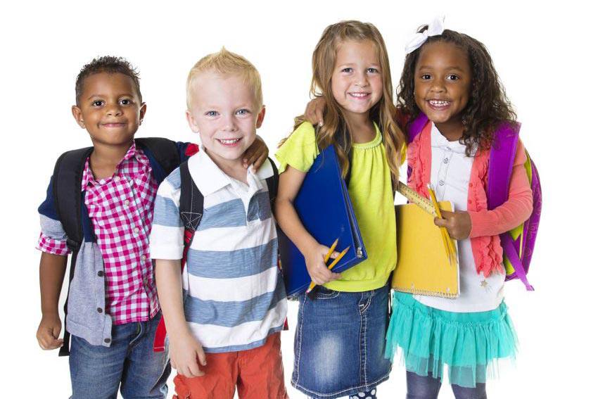 A group of four children with school supplies