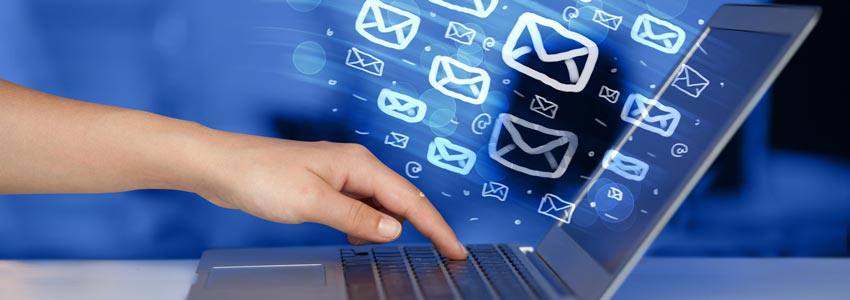 Email messages in icons coming out of a laptop screen