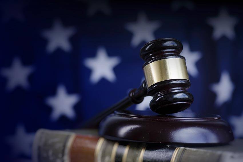 A gavel on a book in front of the US flag