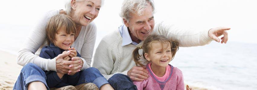 Grandparents at the beach with their grandchildren