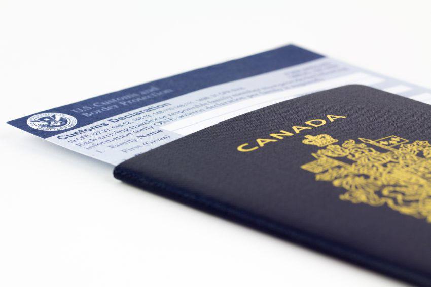 A canadian passport with declaration papers inside it