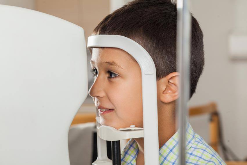 A child using a machine to test their eyes
