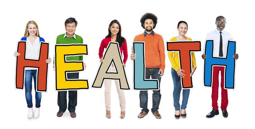A group of people holding letters that spell "HEALTH"