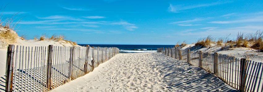 A closed path on the sand leading to the beach