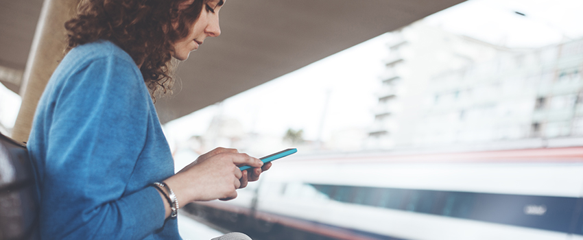 A woman looks at her phone