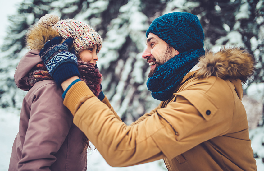 A man and his daughter smiling in winter