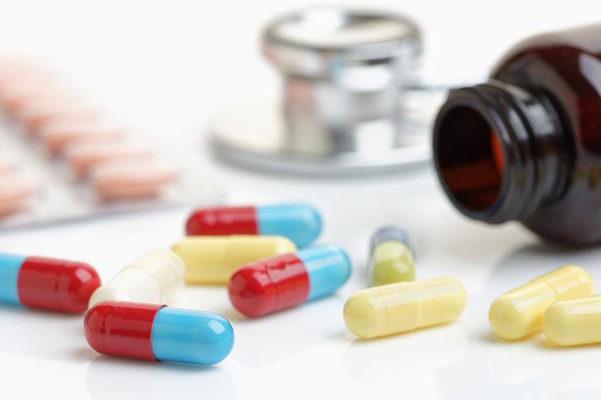 A lot of different pills spilled on a table