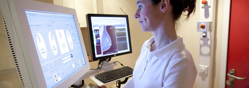 A woman analyzing the pictures of a mammogram 