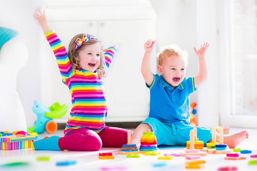 Two children having fun playing with small toys
