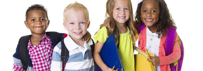 A group of four children with school supplies